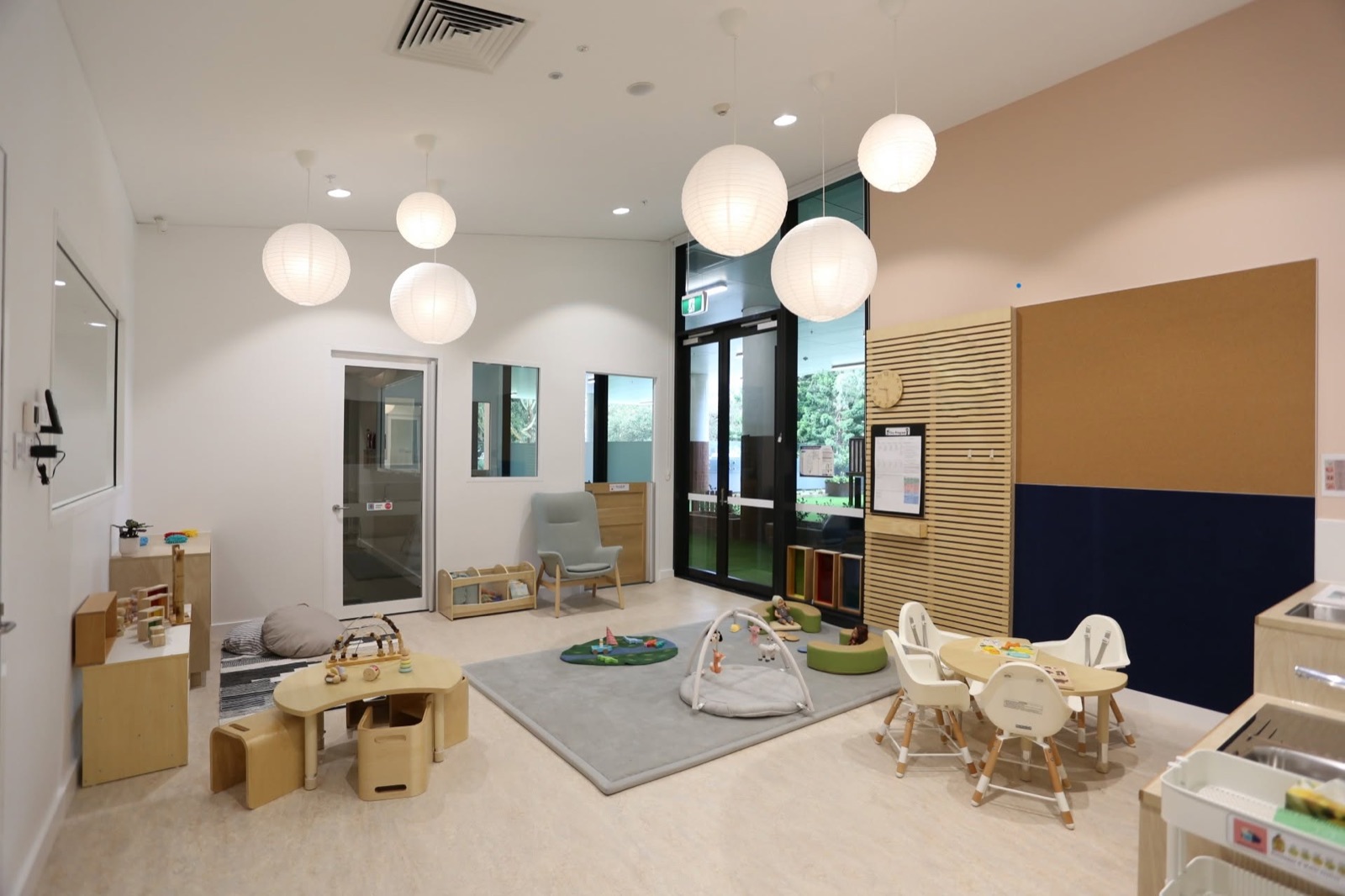 Our nursery room with a soft play mat, low chairs and a cosy corner
